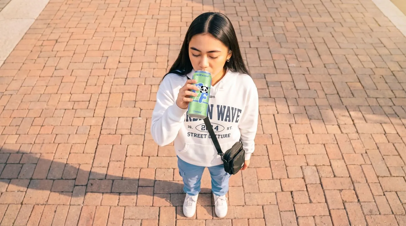 girl drinking from a FRESH N FRESH can