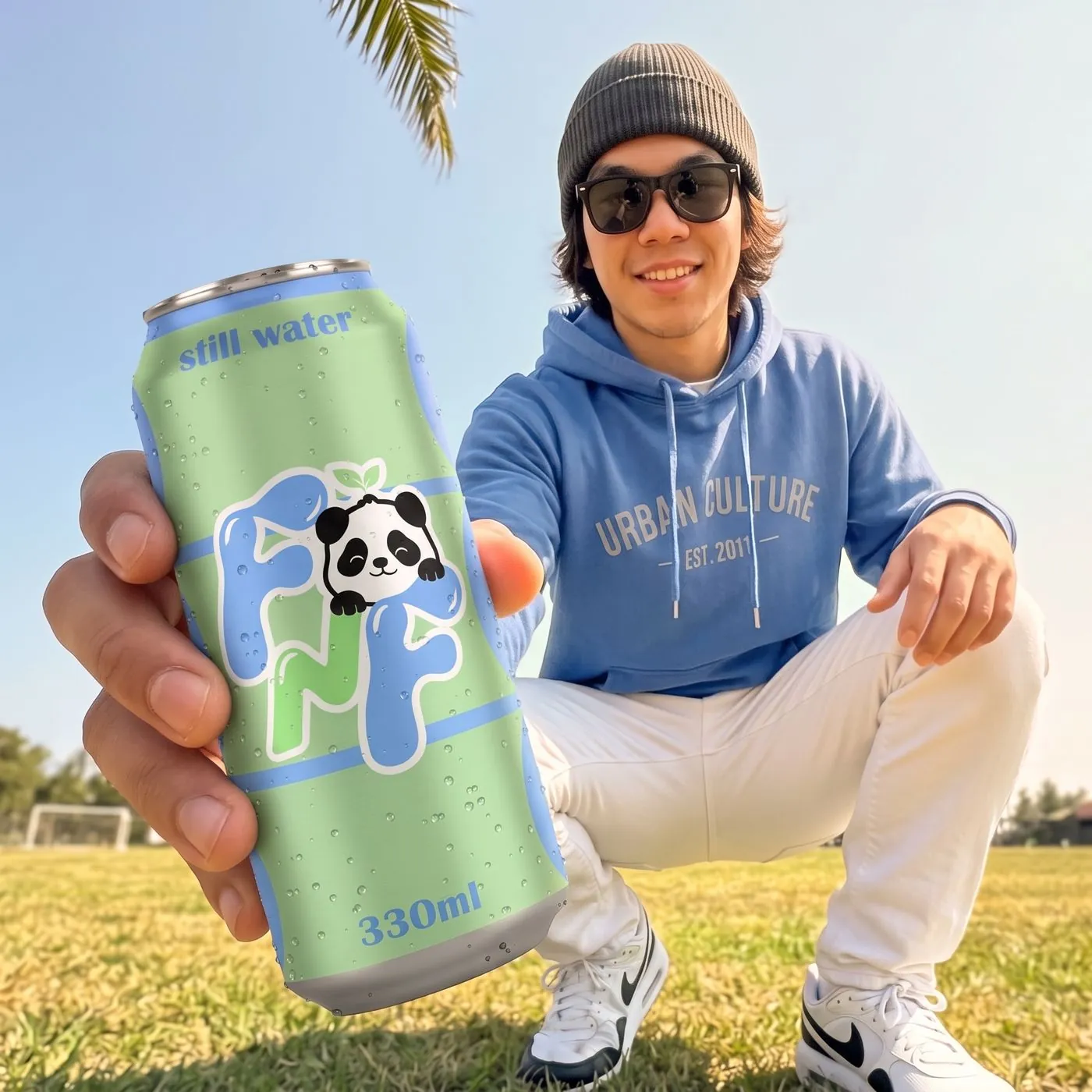 young man holding a FRESH N FRESH can